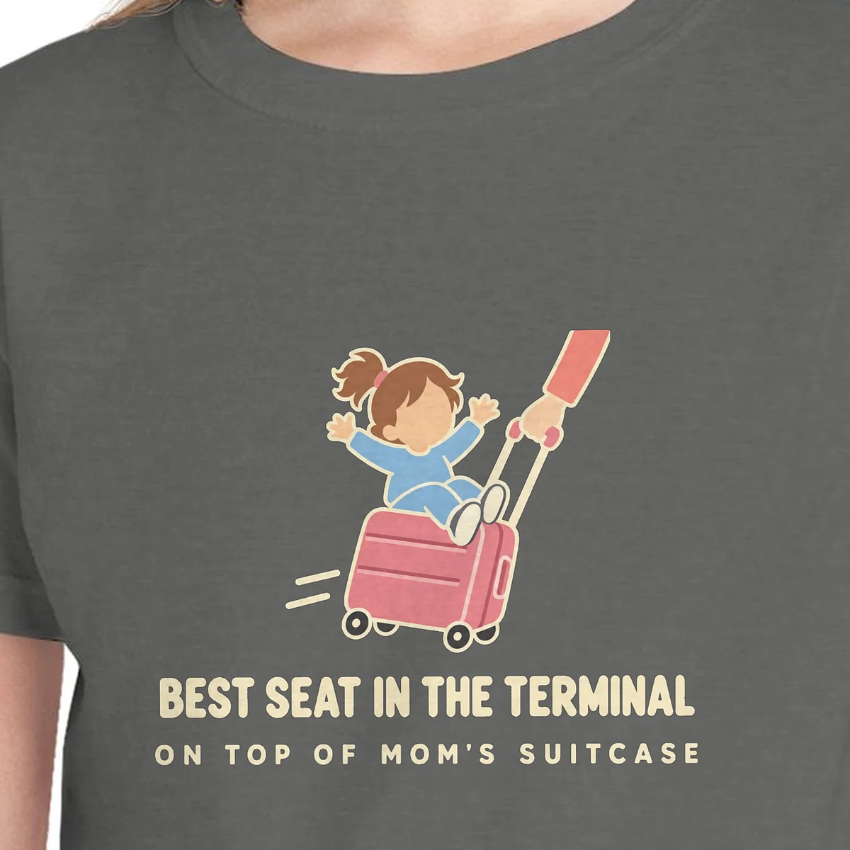 Close-up of the Best Seat in the Terminal design on the Pepper kids tee, Comfort Colors 9018 youth tee, with the neckline