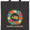 Close-up of the Blooms and Biplanes design printed in warm cream ink on a black canvas tote, with the top seam and handles