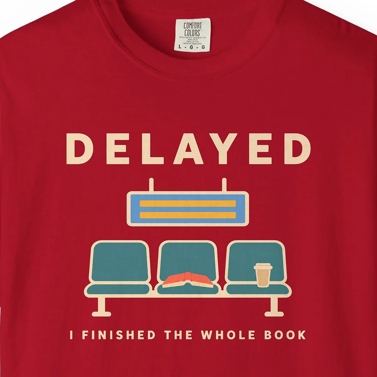 Delayed with a Book Tee in Red, close-up