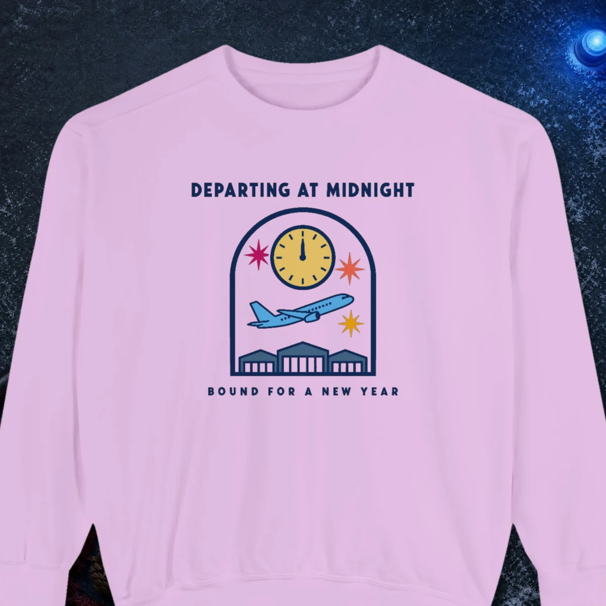 Departing at Midnight design on a Orchid Comfort Colors 1566 sweatshirt, laid flat on a winter ground