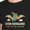 Close-up of the Dinosaur Flying Lessons design on the Black kids tee, Comfort Colors 9018 youth tee, with the neckline