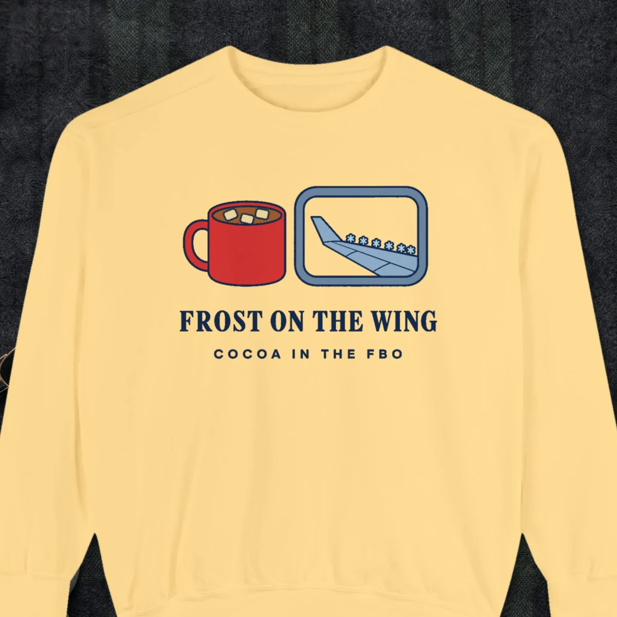 Frost on the Wing design on a Butter Comfort Colors 1566 sweatshirt, laid flat on a winter ground