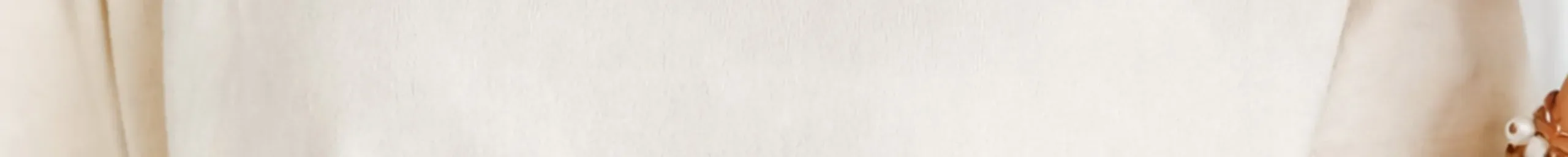 A garment-dyed Comfort Colors tee in Ivory, showing the soft uneven surface of pigment dye.