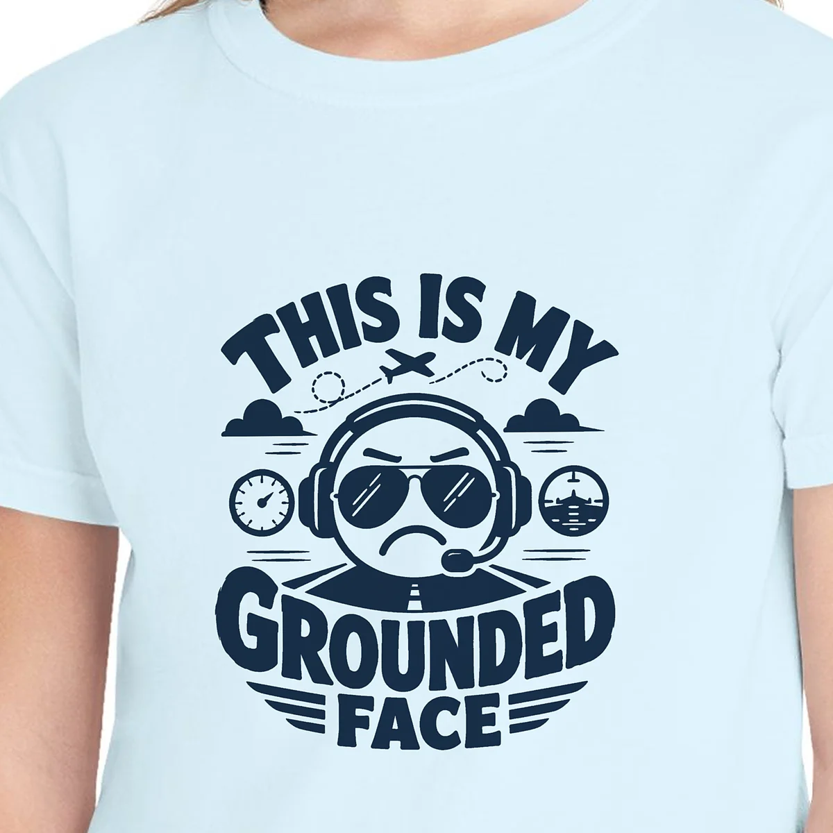 Close-up of the Grounded Face Arched design on the Chambray kids tee, Comfort Colors 9018 youth tee, with the neckline