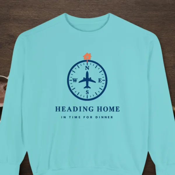 Heading Home design on a Chalky Mint Comfort Colors 1566 sweatshirt, laid flat on a winter ground