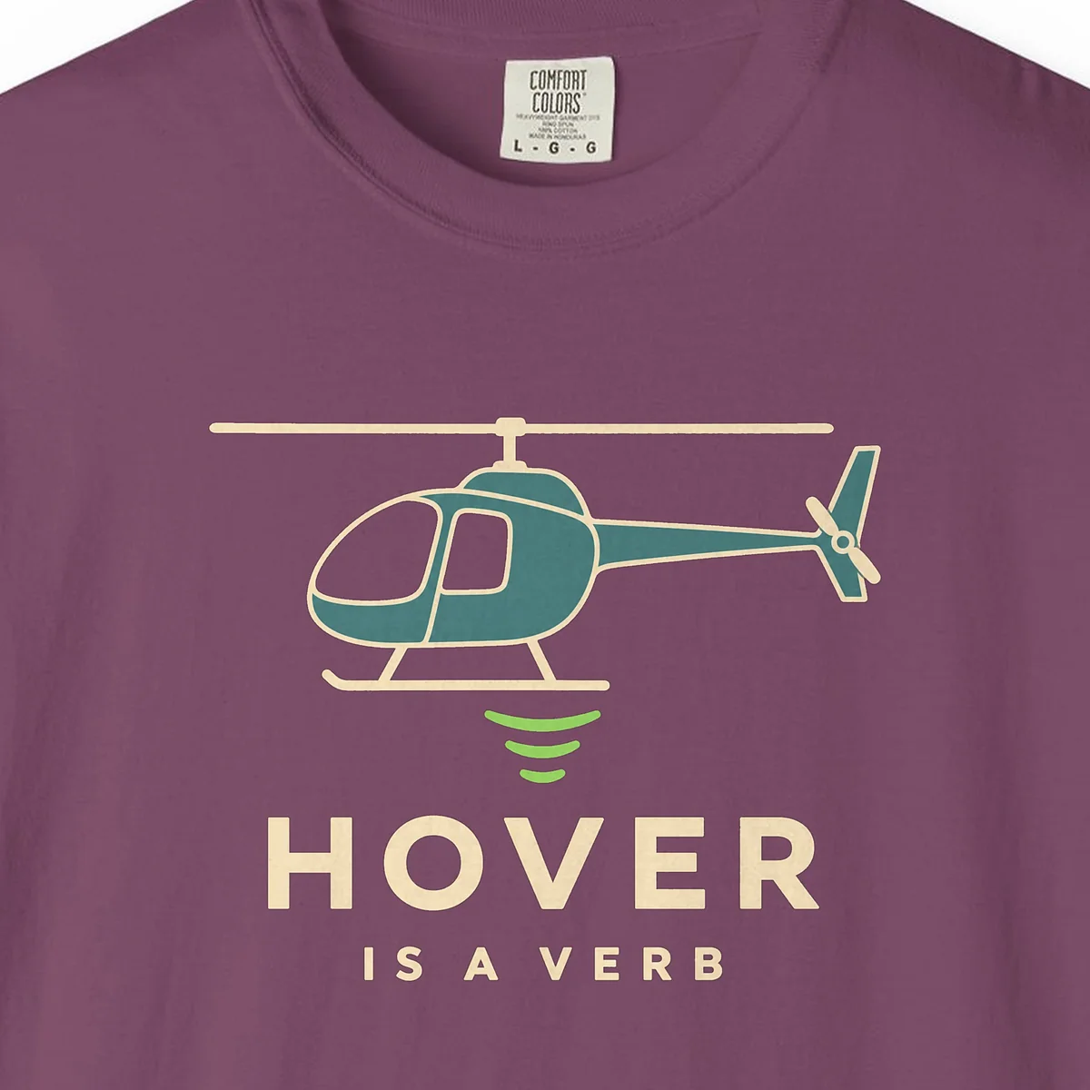 Hover Is a Verb Tee in Berry, close-up