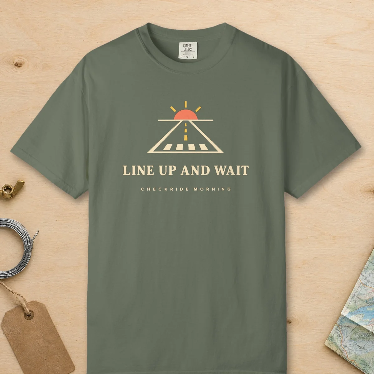 Line Up and Wait Tee in Moss, front view
