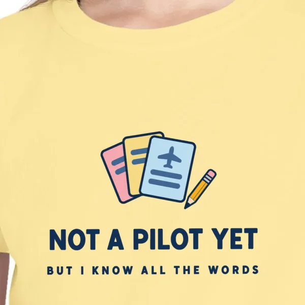 not-a-pilot-yet-kids-tee-butter-chest Close-up of the Not a Pilot Yet design on the Butter kids tee, Comfort Colors 9018 youth tee, with the neckline
