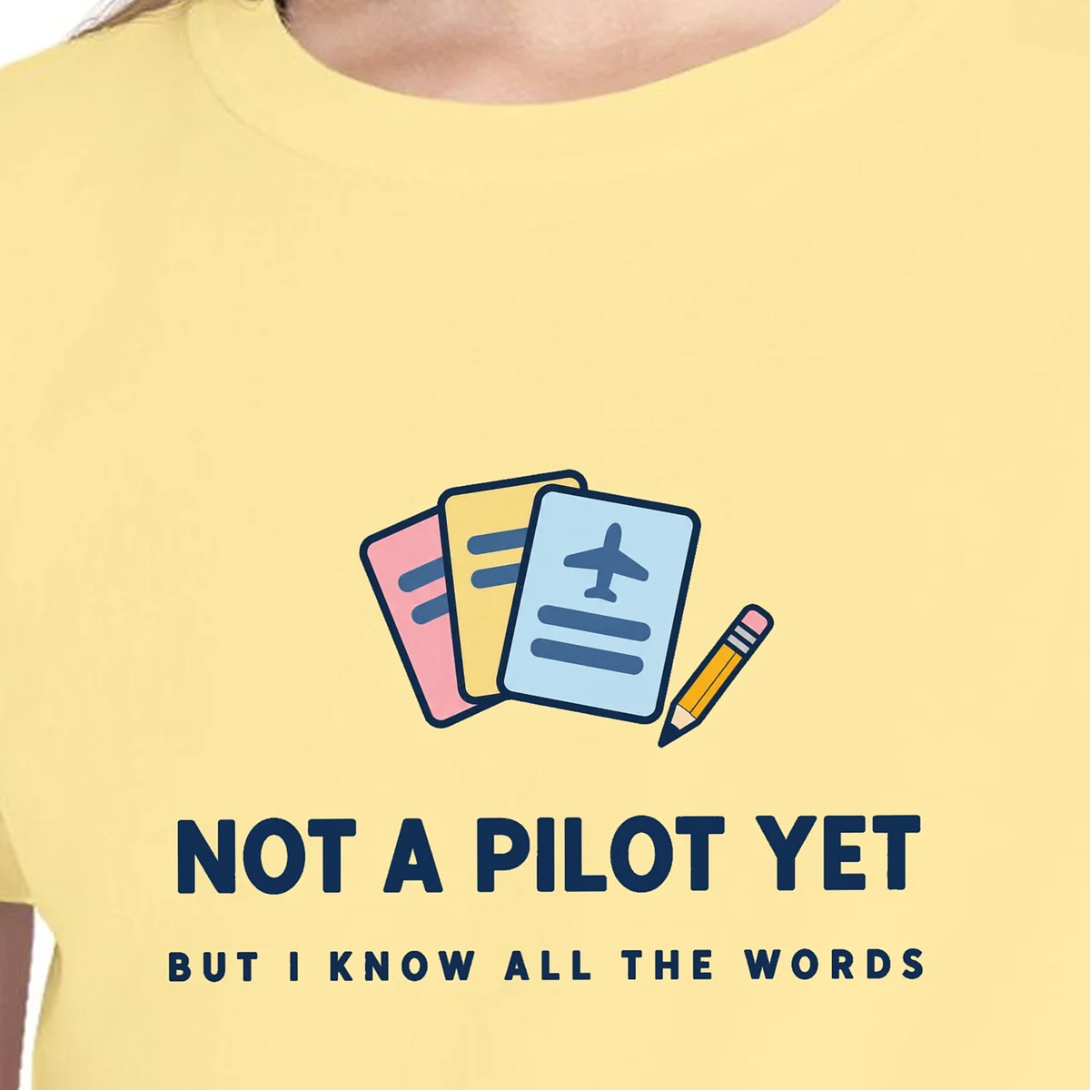 Close-up of the Not a Pilot Yet design on the Butter kids tee, Comfort Colors 9018 youth tee, with the neckline