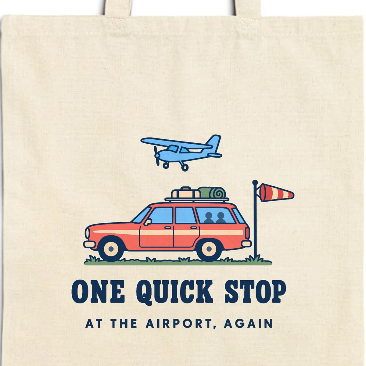 Close-up of the One Quick Stop design printed in navy ink on a natural canvas tote, with the top seam and handles