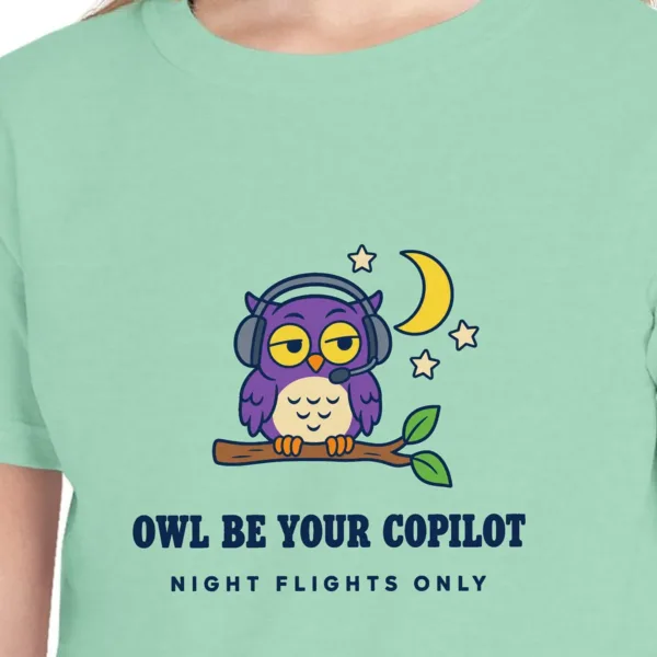 Close-up of the Owl Be Your Copilot design on the Island Reef kids tee, Comfort Colors 9018 youth tee, with the neckline