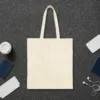 Plain back of the natural canvas tote with the Picnic at the Fence design, printed on the front only