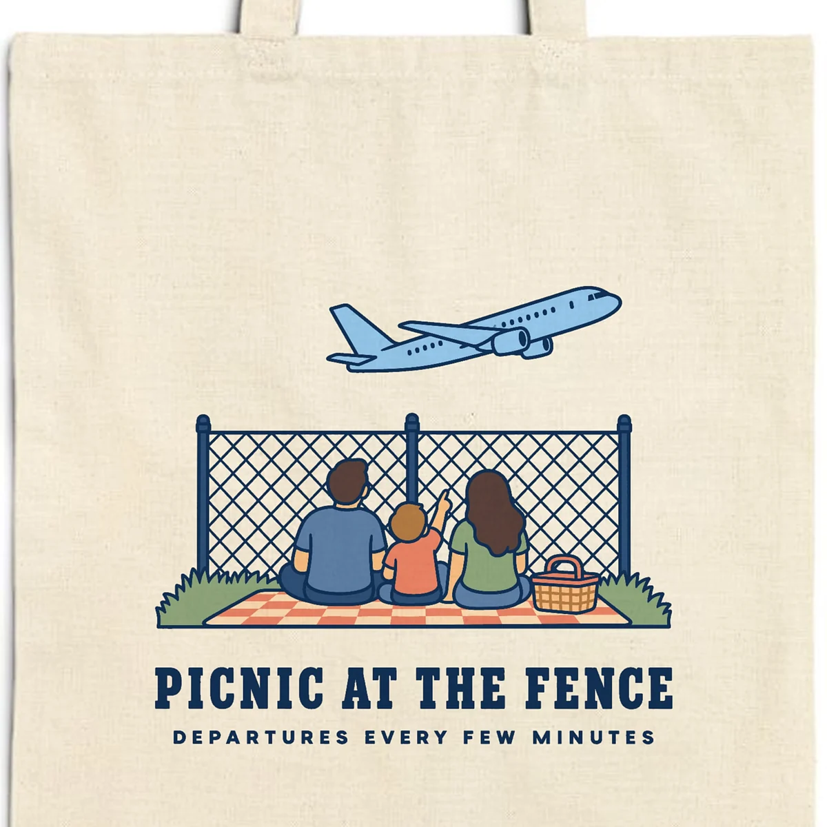 Close-up of the Picnic at the Fence design printed in navy ink on a natural canvas tote, with the top seam and handles