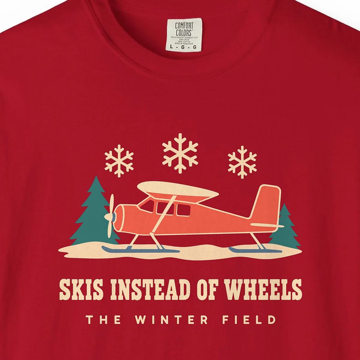 skis-instead-of-wheels-tee-red-chest Skis Instead of Wheels Tee in Red, close-up