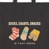 Close-up of the Socks Charts Snacks design printed in warm cream ink on a black canvas tote, with the top seam and handles