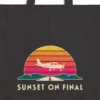 Close-up of the Sunset on Final design printed in warm cream ink on a black canvas tote, with the top seam and handles