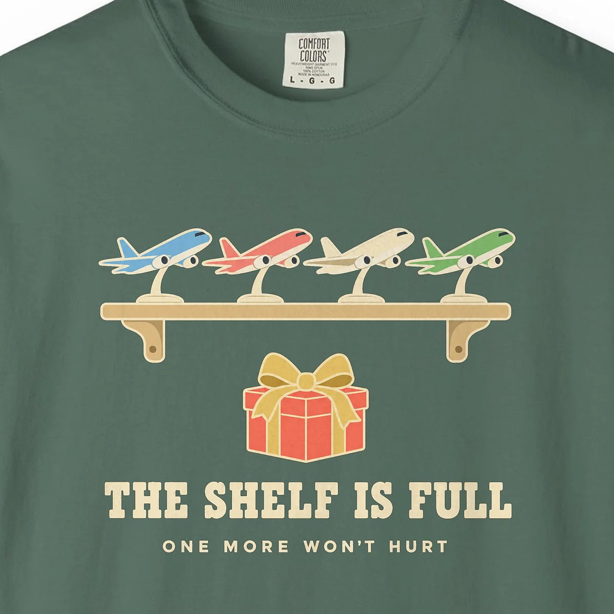 the-shelf-is-full-tee-blue-spruce-chest The Shelf Is Full Tee in Blue Spruce, close-up
