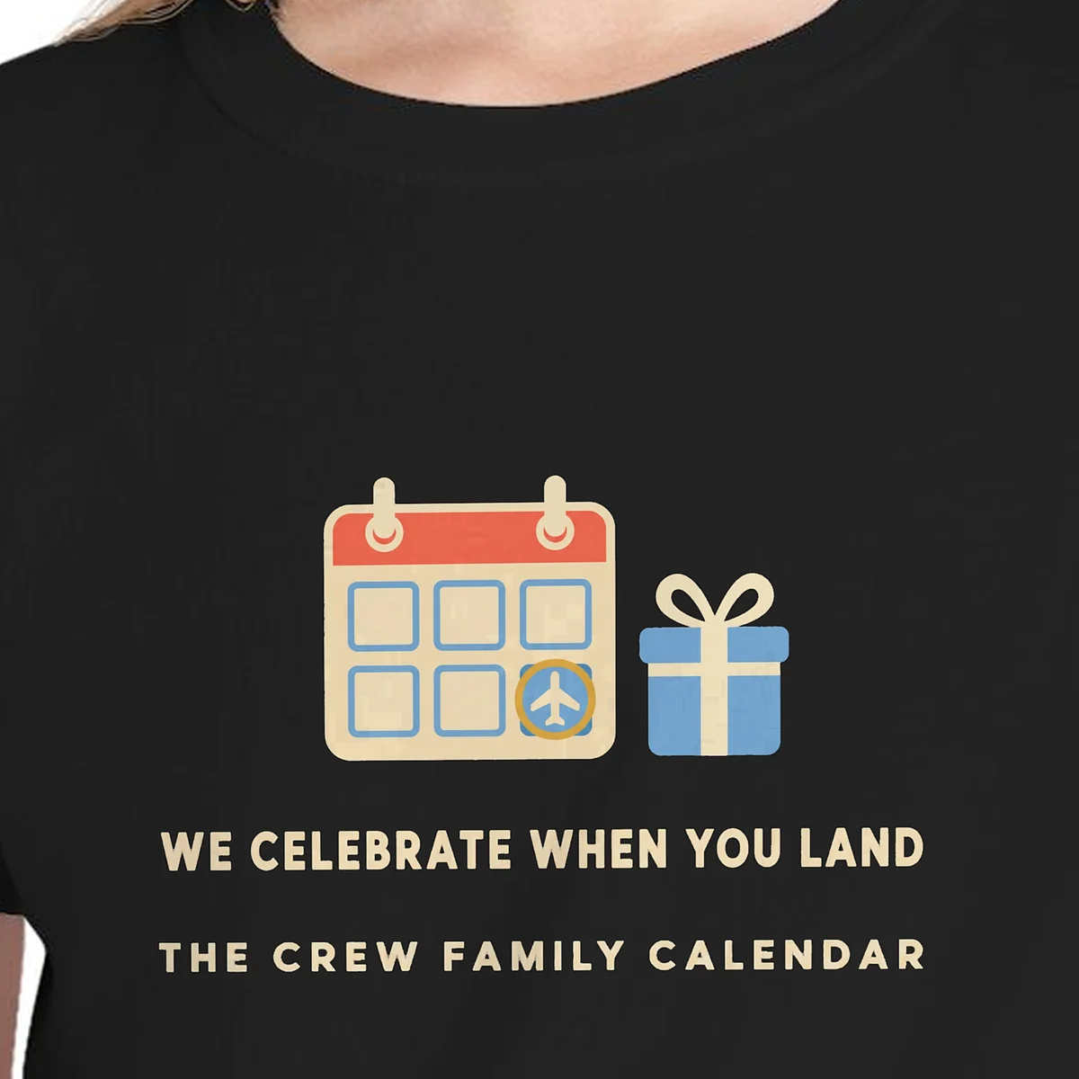Close-up of the We Celebrate When You Land design on the Black kids tee, Comfort Colors 9018 youth tee, with the neckline