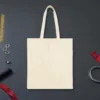 Plain back of the natural canvas tote with the We Met at the Airport design, printed on the front only