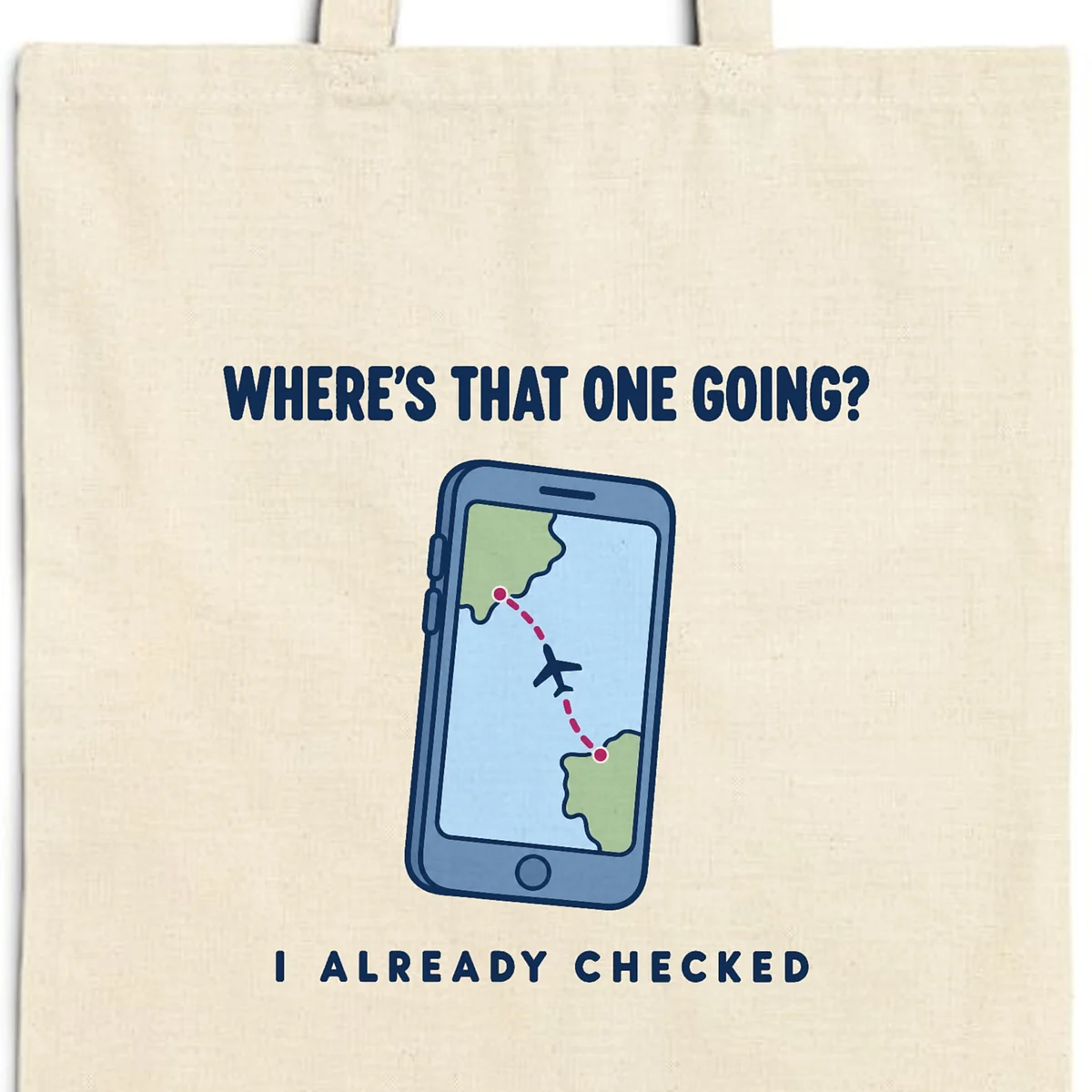 Close-up of the Where's That One Going design printed in navy ink on a natural canvas tote, with the top seam and handles
