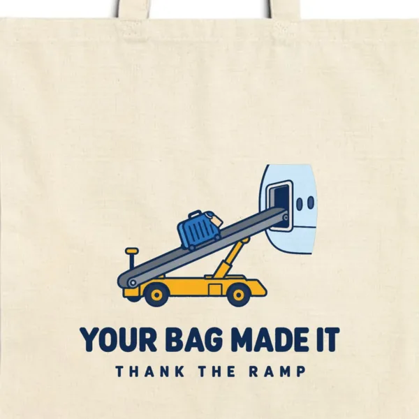 Close-up of the Your Bag Made It design printed in navy ink on a natural canvas tote, with the top seam and handles