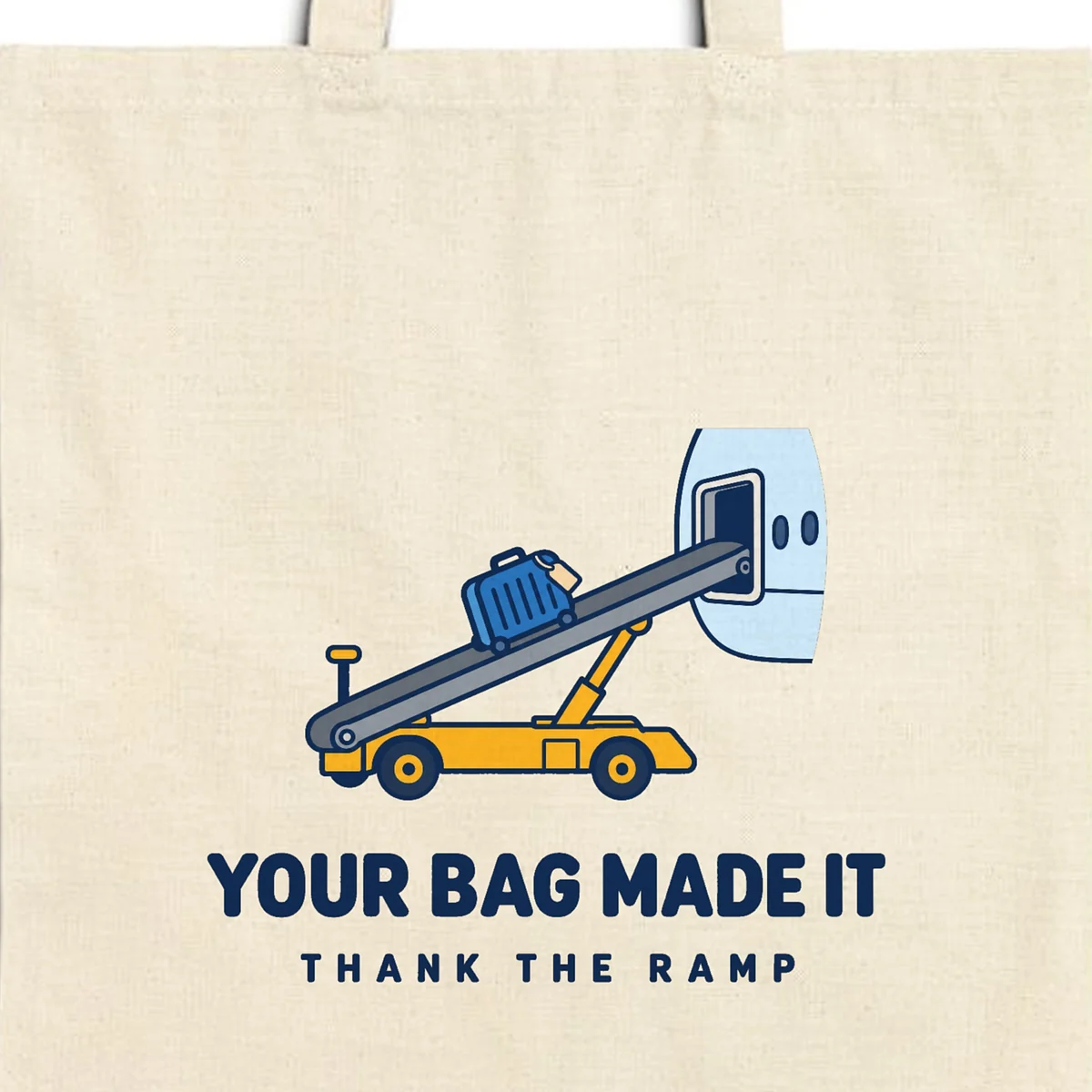 Close-up of the Your Bag Made It design printed in navy ink on a natural canvas tote, with the top seam and handles